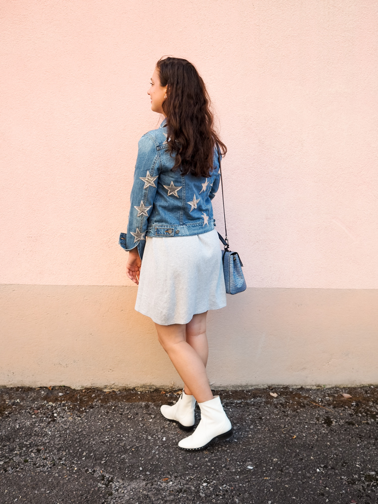 Cristina from The Brunette Nomad, Dallas fashion blogger living in Switzerland, is styling her star printed denim jacket on the blog