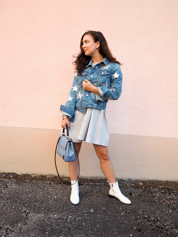 Cristina from The Brunette Nomad, Dallas fashion blogger living in Switzerland, is styling her star printed denim jacket on the blog