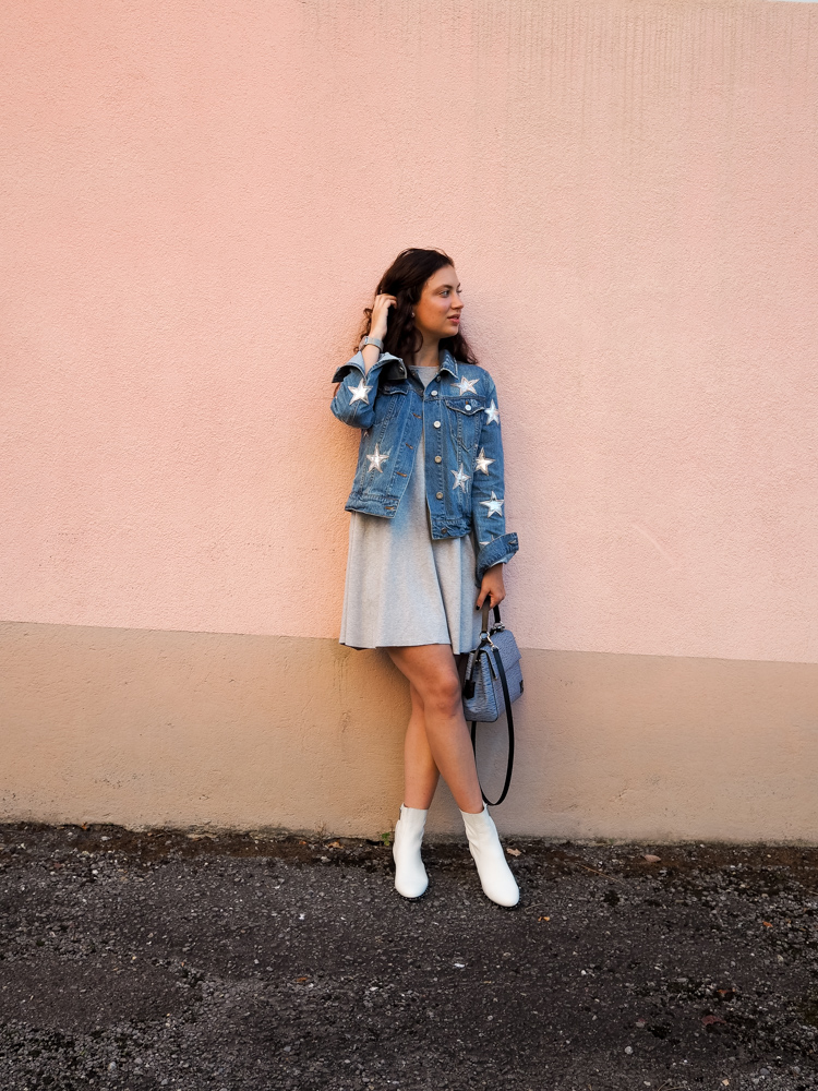 Cristina from The Brunette Nomad, Dallas fashion blogger living in Switzerland, is styling her star printed denim jacket on the blog